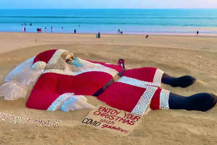 Sudarsan Pattnaik creates Santa Claus sand sculpture made of roses