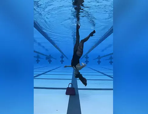 Viral video: Woman swimming champion clad in high-heels walks upside down in pool!