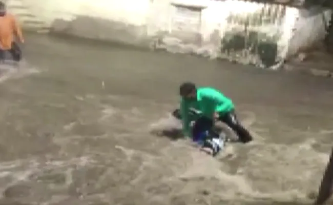 Watch: Biker gets swept away as roads turn into rivers in Hyderabad rain  