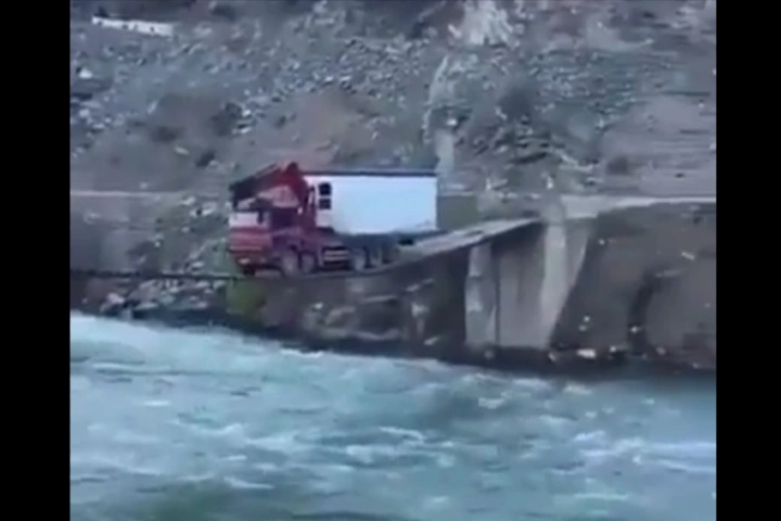 Stunning Video:  Dare devil truck driver crosses precariously hanging narrow bridge