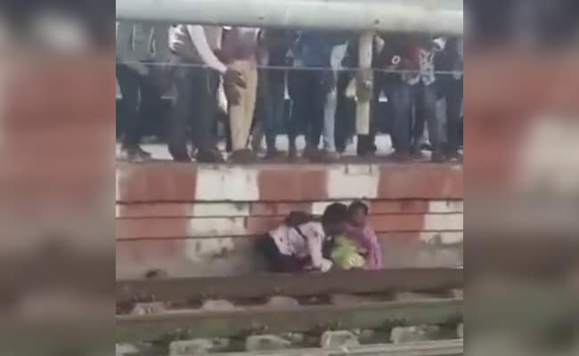 Video: Mother, son stuck between track and platform have miraculous escape as train speeds through in Karnataka